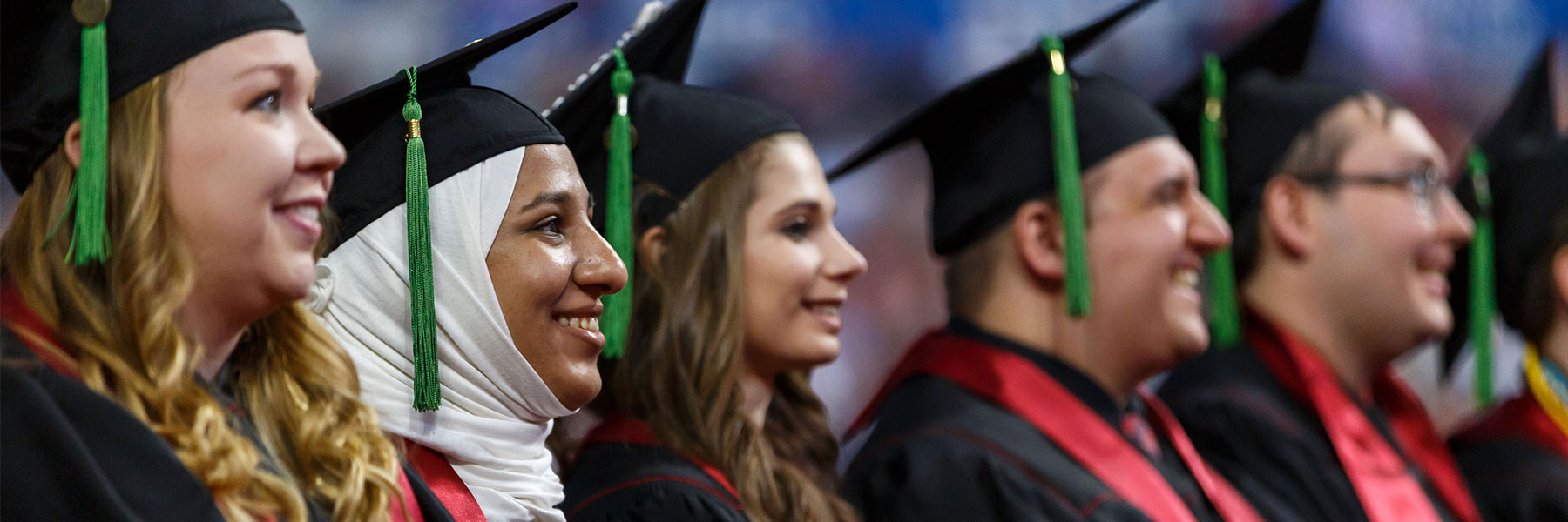 Profile view of a row of four students at IUPUI Graduation.