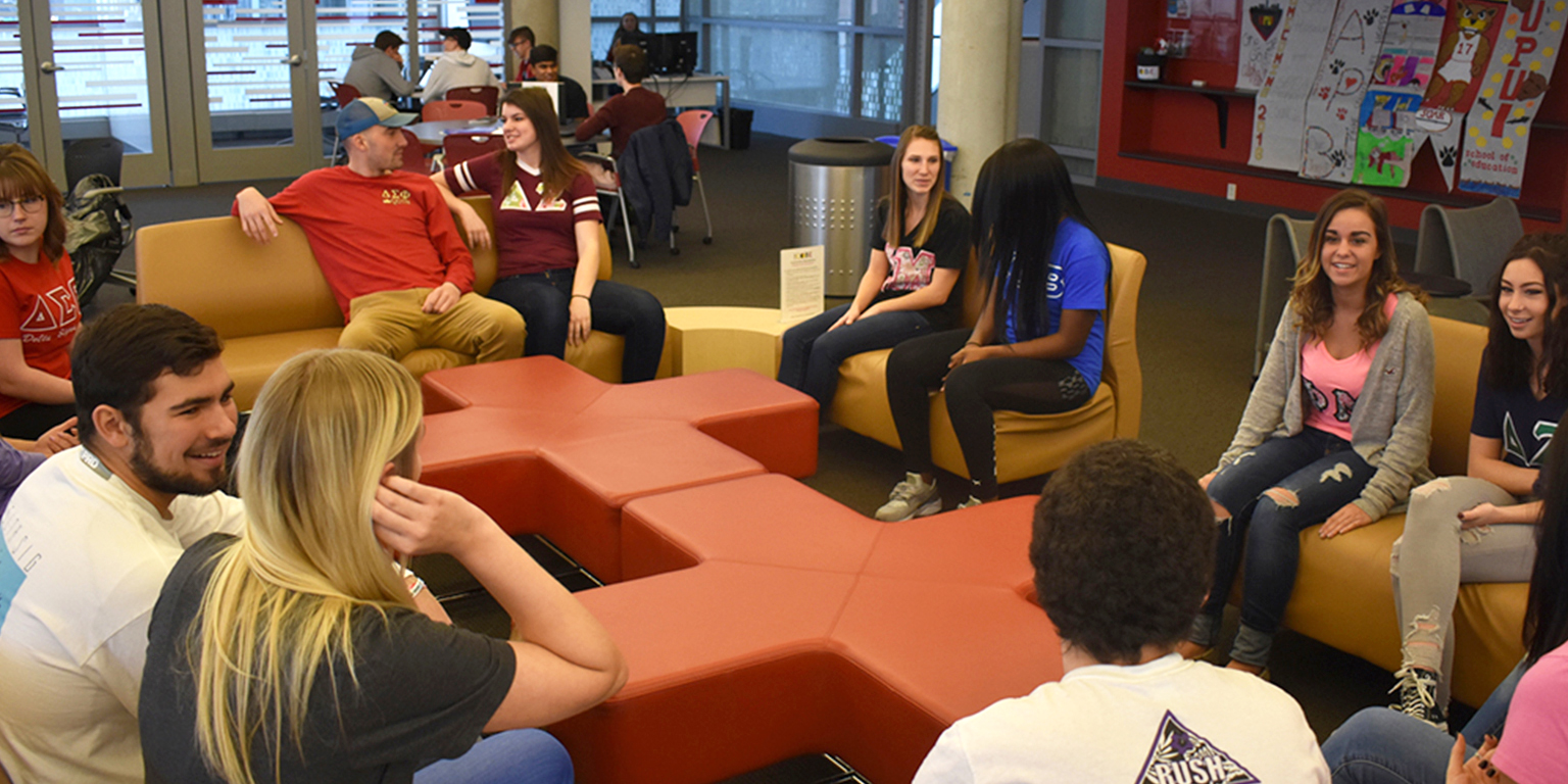 Various students socialize in the cube.