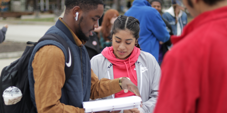 Two students at last year's march to the polls event, signing up to vote.