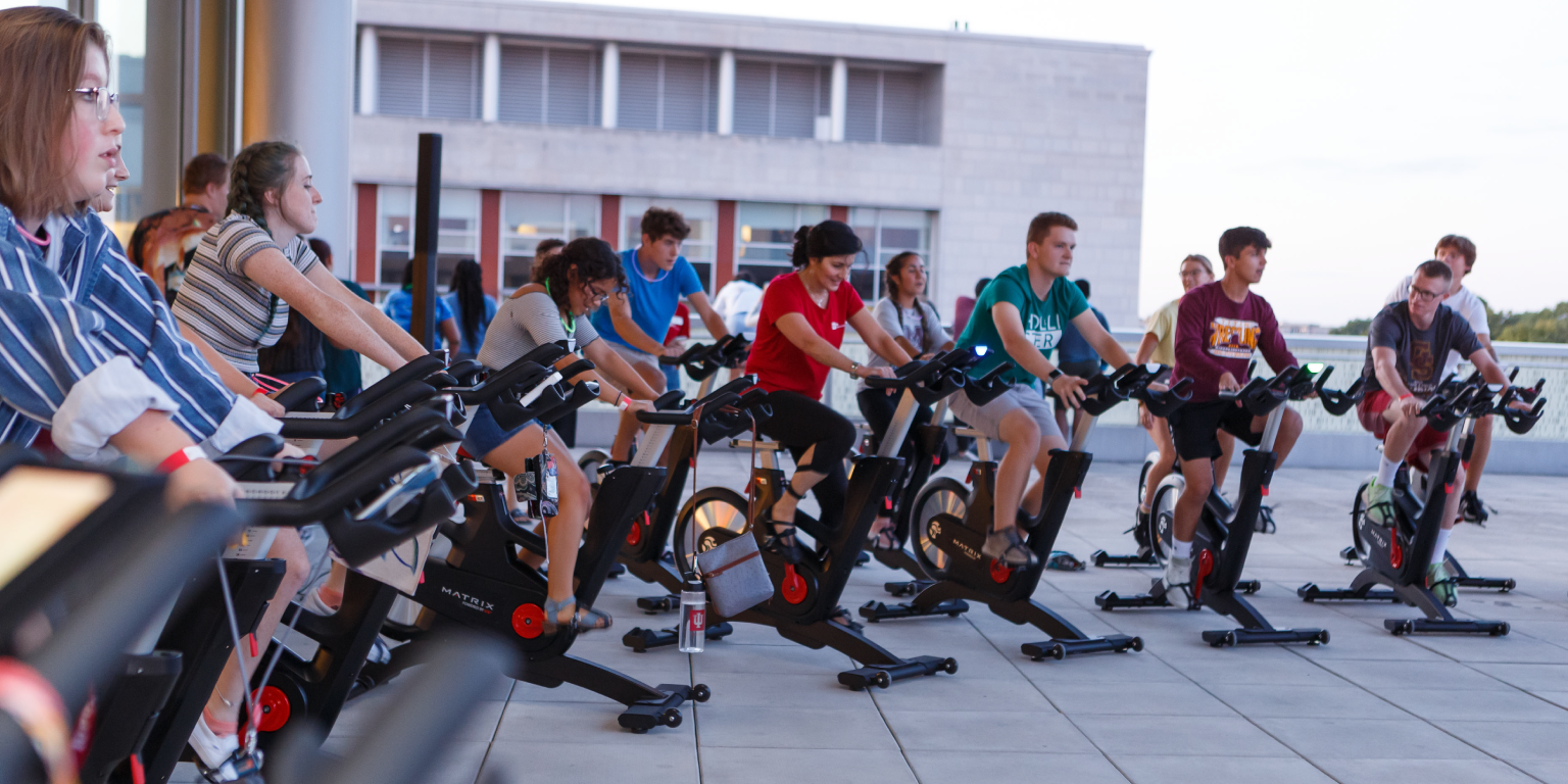 Students cycling on the campus center 4th floor terrace.