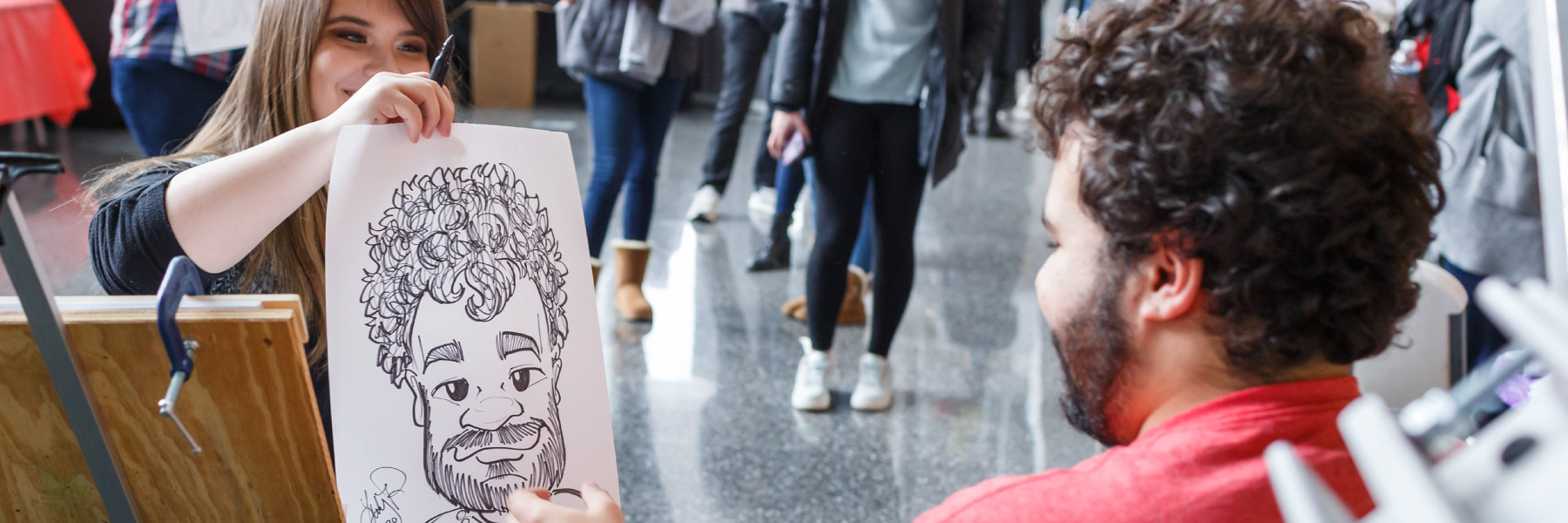 A student gets his caricature handed to him.
