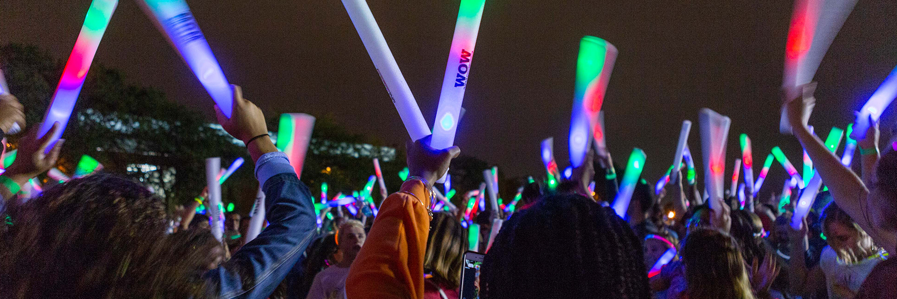 Students raise and wave their glow sticks at the light up the night event.