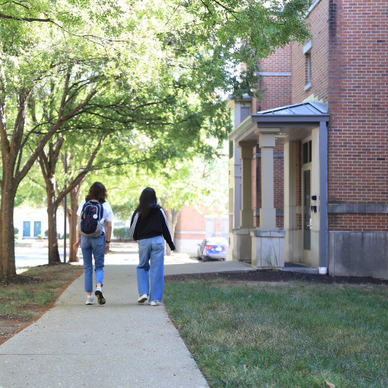 Two students walking around Riverwalk apartements.