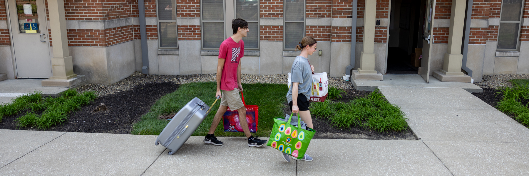 Student bringing things to their building for housing move-in.