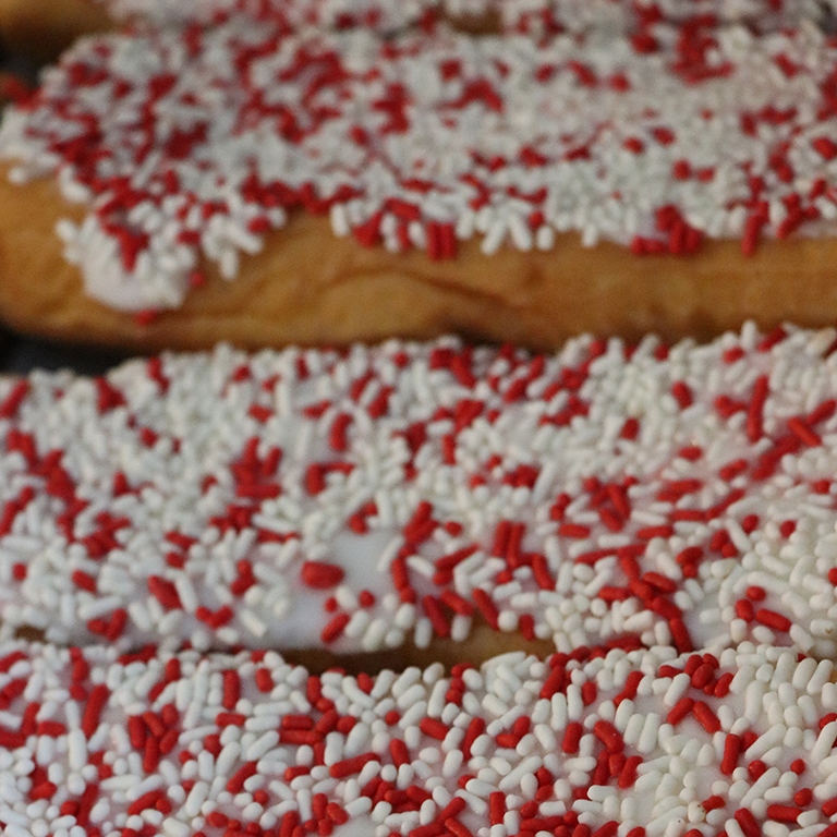 Red and white sprinkled donuts.